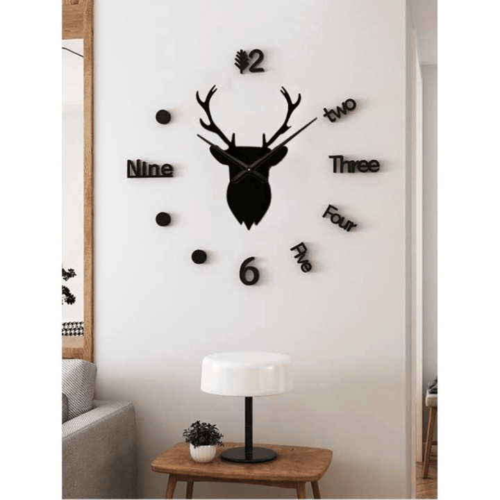 Black deer head wall clock with numbers on a white wall